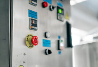 Paper 6 Temperature control panel with buttons on a refrigerator in a specialty alcoholic beverage production plant